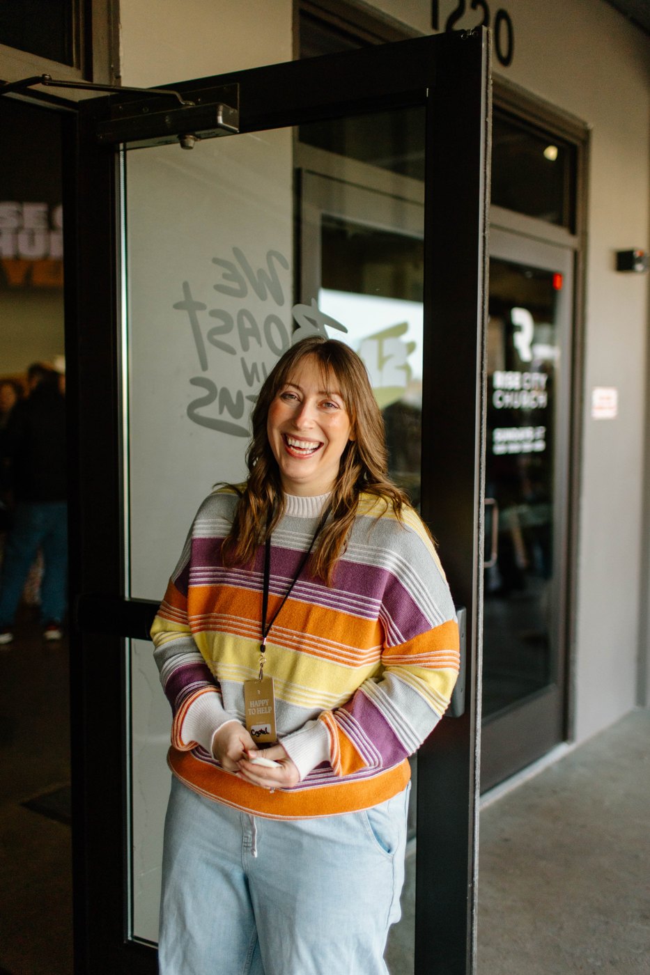 A smiling face welcoming people at Rise