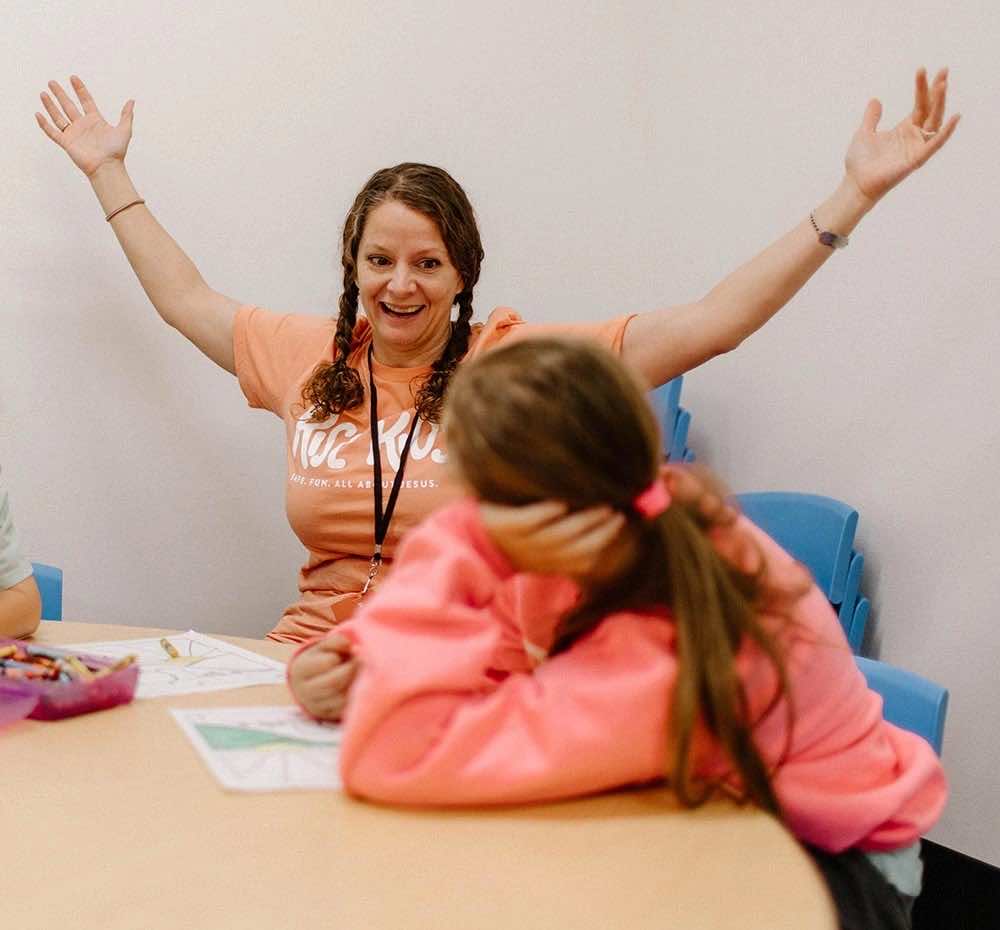 A Rise Kids leader welcoming and encouraging a child
